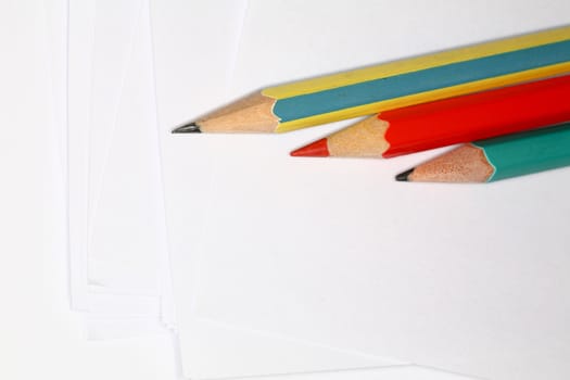 Closeup image of pencils laying on white paper