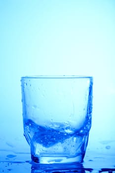 An image of a glass on blue background