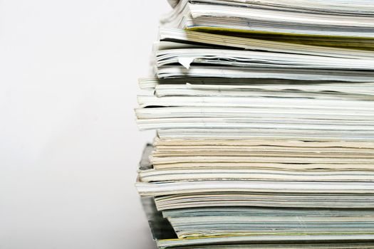 Stack of magazines on neutral background closeup
