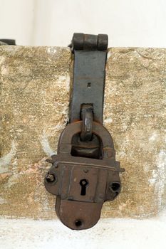 An image of antique padlock on neutral background
