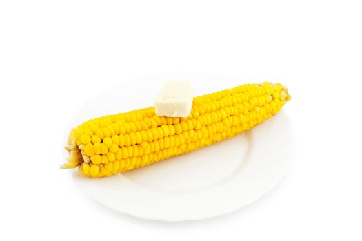 Boiled corn with a piece of butter on plate.