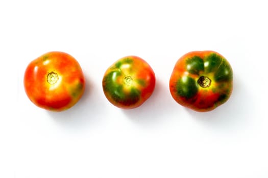 An image of three tomatos on white background