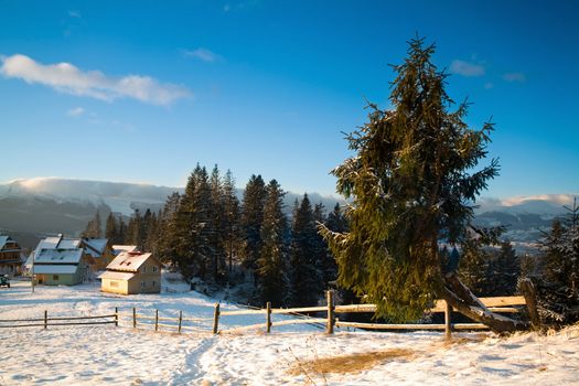 An image of a village in winter mountains