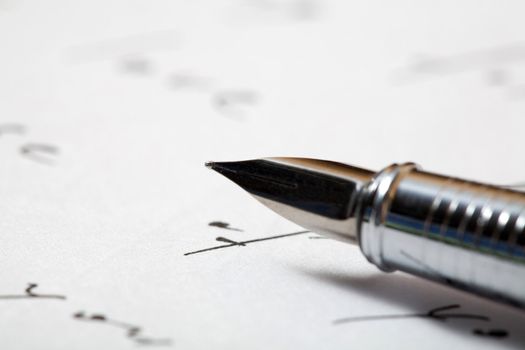 An image of a pen on a  background of a letter