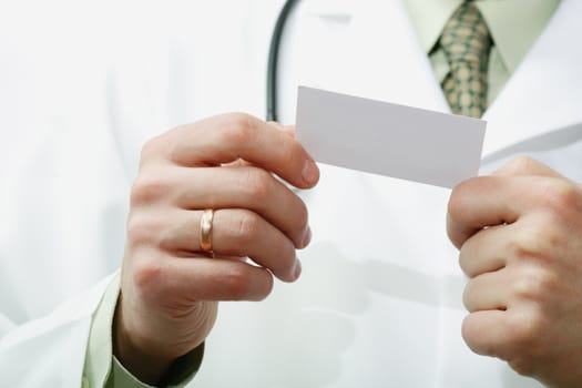An image of doctor's hand holding a card