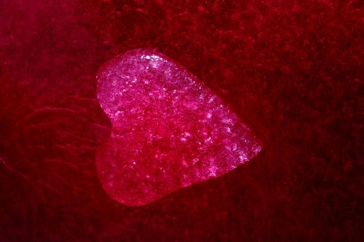 Stock photo: an image of a red icy heart on a purple background