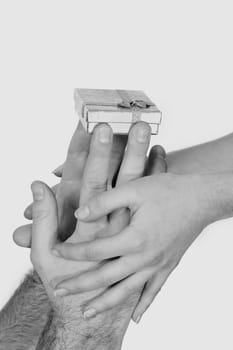 Stock photo: an image of two pairs of hands with present 