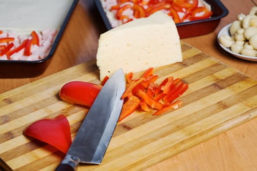 Stock photo: an image of food in the kitchen: mushrooms, cheese, paprika and knife