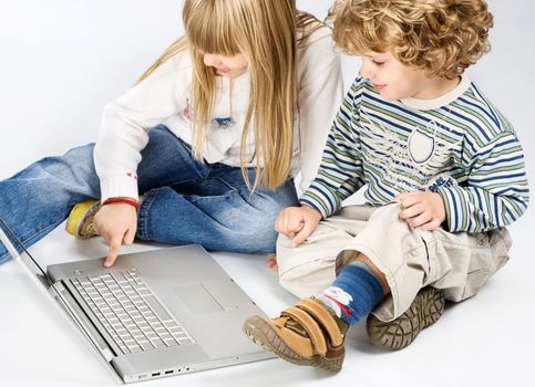 Curl hair boy and blue hair girl trying to turn on computer in front of them