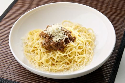 Spaghetti pasta with meat and cheese on the table in restaurant