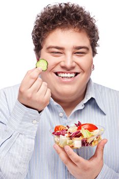 Happy young chubby man with fresh salad, isolated on white