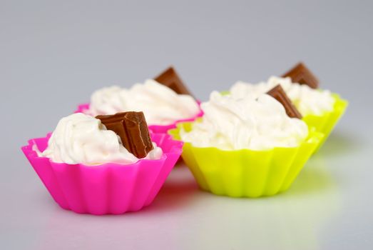 Four portions of whipped cream over white background. 