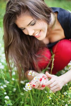 Pretty woman in park gather spring flowers, outdoor