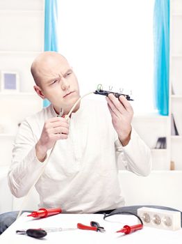 man repair an extension cord at home