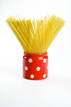 Spaghetti inside a red jar isolated on white background