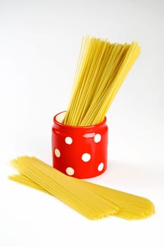 Spaghetti inside a red jar isolated on white background
