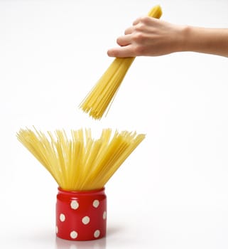 Woman's hands holding red jar full of spaghetti inside.  Isolated on a white background.