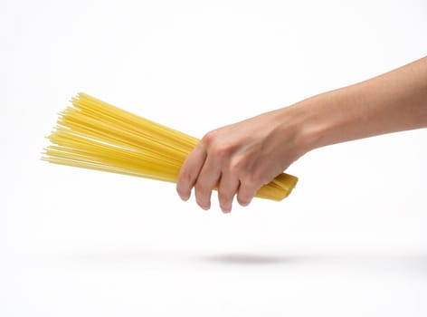 Woman's hand holding bunch of spaghetti.  Isolated on a white background.