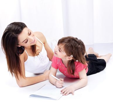 Woman and child drawing on notepad and laughing