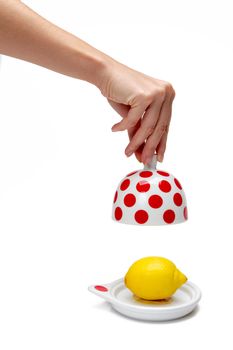 Woman's hand opening bank with lemon inside on a white background