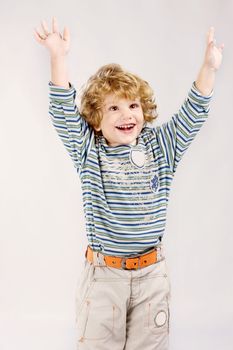 Happy curl blue hair male child holding hands up