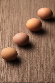 Brown eggs in a line on white background