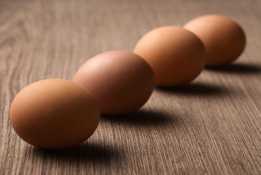 Brown eggs in a line on white background