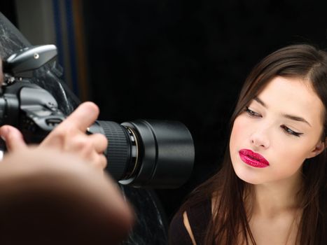 Pretty female model on photo shooting in studio