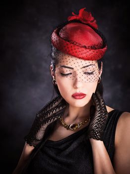 Portrait of a pretty woman with red hat and black gloves