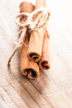 Cinnamon sticks close up on wooden table