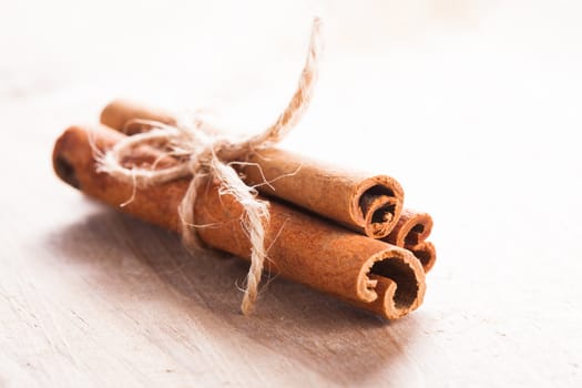 Cinnamon sticks close up on wooden table