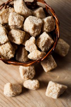 Brown sugar, natural cubes closeup in basket