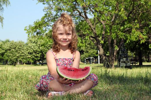 little girl holding watermelon