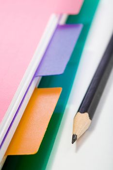 Stock photo: office theme: an image of part of pink notebook and a pencil