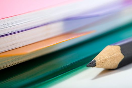 Stock photo: office theme: an image of part of a pink notebook and a pencil