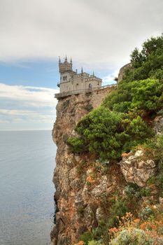 The old castle in the Gothic style on cliff above the sea