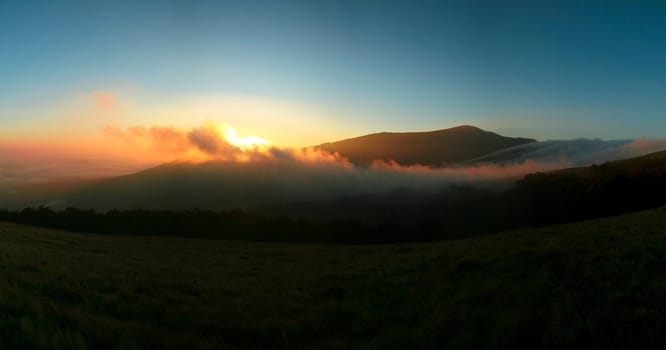 An image of a sunrise in mountains 