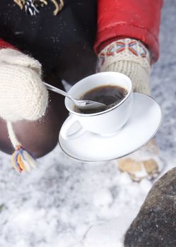 Holding a cup of Coffee with winter gloves