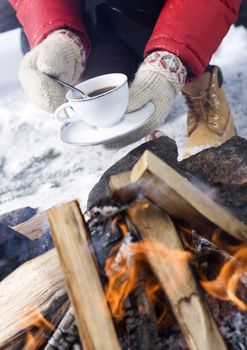 Holding a cup of Coffee with winter gloves