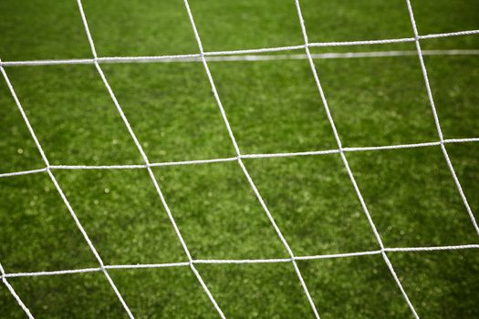 sport background, net on green grass, selective focus