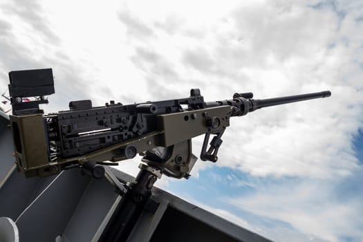 machine gun on warship against dark sky
