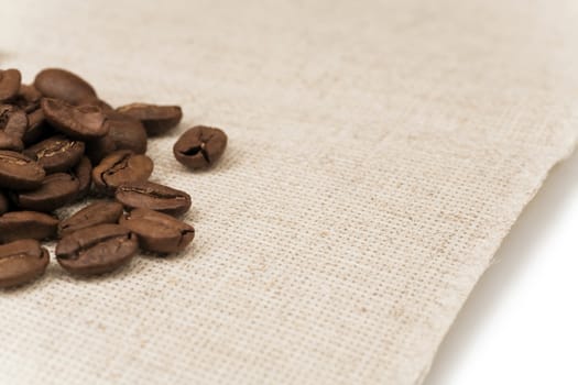 roasted coffee beans on a yellow paper napkin