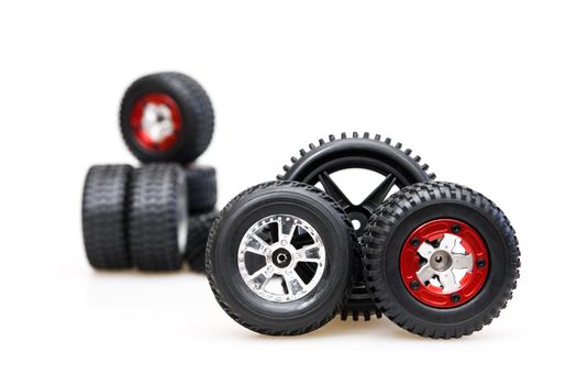 Rubber tires on red rims on a white background