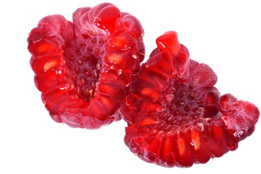 two halves of ripe red raspberry on white background