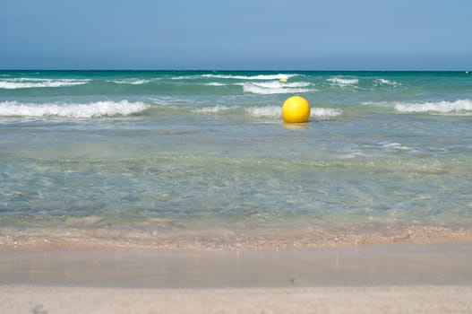 Sea view from sand beach and yellow buoy