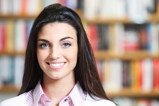 portrait of beautiful young female student in library