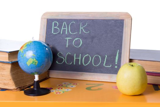 Back to school word on board, books and globe on student table