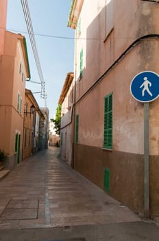 Pedestrian road in usual european city, pink buildings