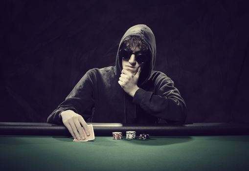 Portrait of a professional poker player sitting at a poker table