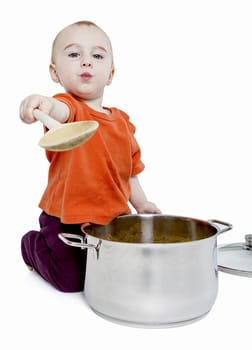 baby with big cooking pot and wooden spoon isolated on white background